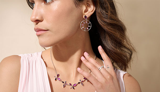 Woman wearing purple and pink orchid jewelry